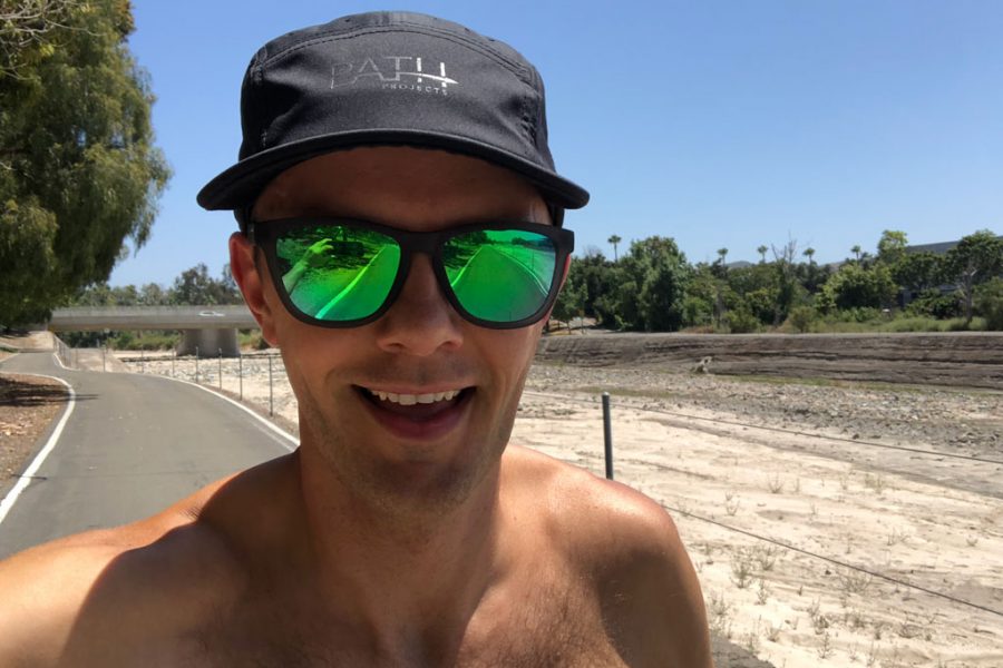 floris gierman running with a hat and sunglasses on